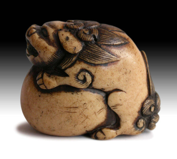 19th Century Japanese Carved Kara Shishi Temple Lion on Ball Stag Antler Netsuke